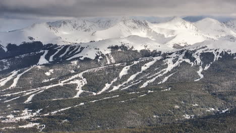 Vail-pass-i70-perspective-of-Copper-Mountain-ski-resort-trail-runs-Breck-ten-mile-range-Leadville-Colorado-epic-ikon-Rocky-snowy-winter-spring-snow-field-peaks-late-afternoon-clouds-pan-reveal-forward