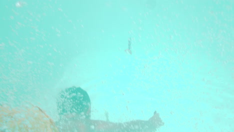 siblings having fun in outside swimming pool