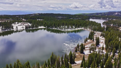 Drone-flyover-of-an-ice-lake-in-summer-at-the-Grand-Mesa-summit