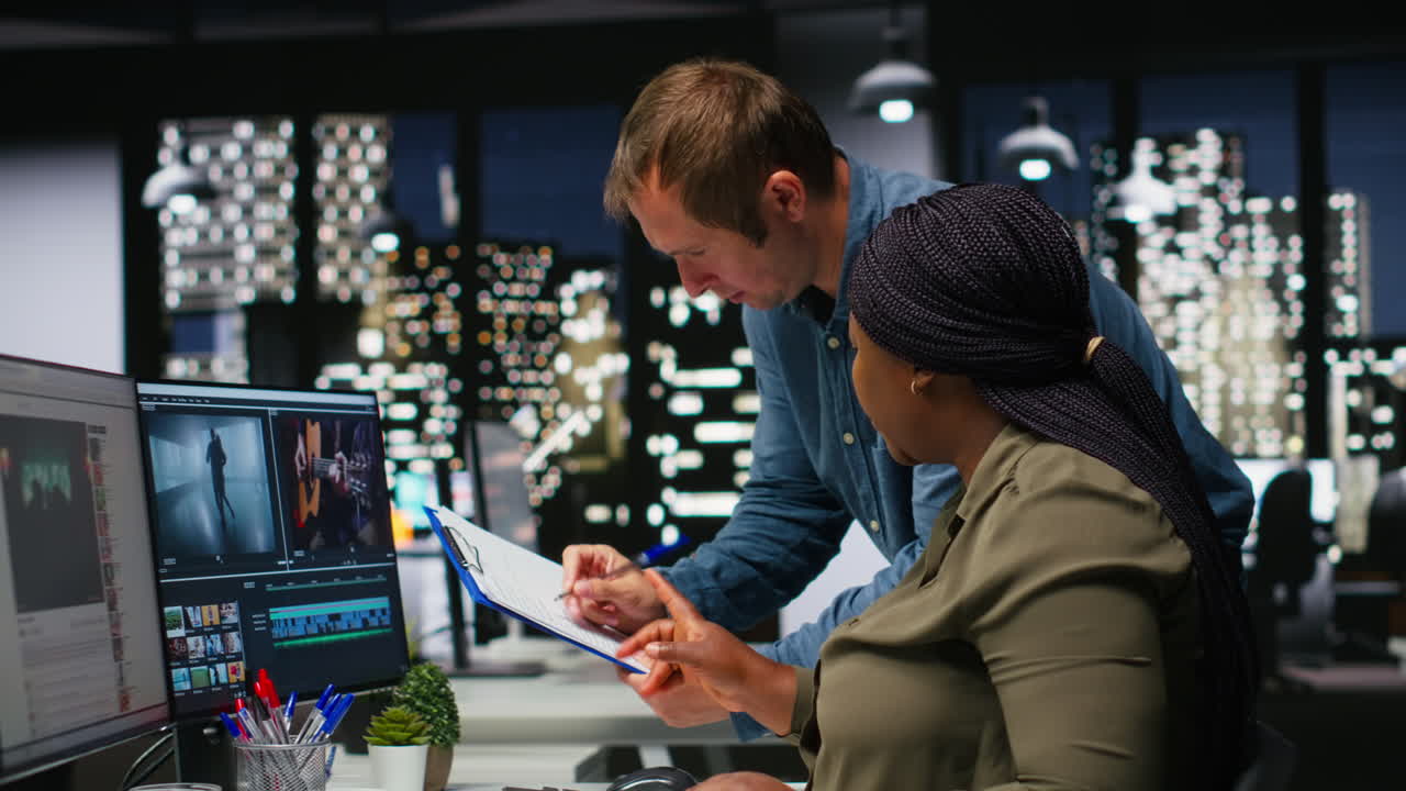 Team of multiethnic videographers editing video shoot in post production