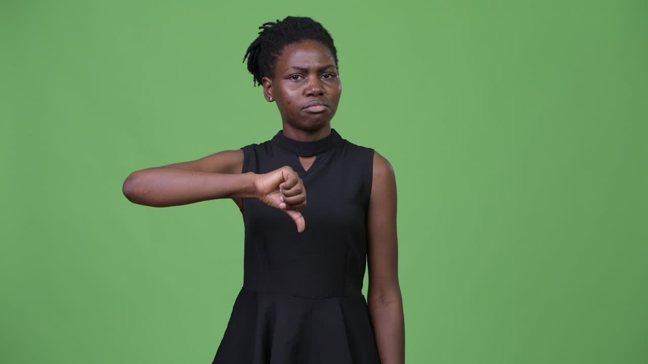 Young sad African businesswoman giving thumbs down