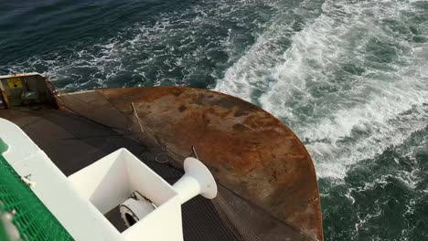 Rusted-Stern-Of-A-Ferry-Boat-Traveling-Across-The-Water-In-Orcas-Island,-Washington,-USA