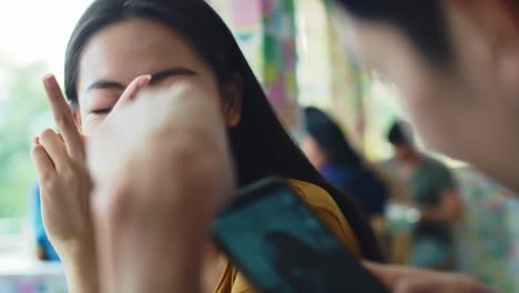 Handheld-view-of-playful-couple-catching-memories-at-cafe