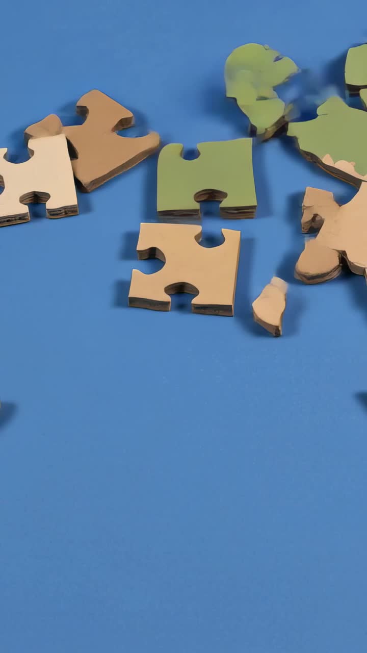 Vertical video: Appearing tan green pieces sliding and interlocking on blue mat, forming world map