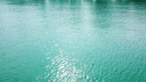 aerial top-down view of the sea surface with deep blue water, moving forward