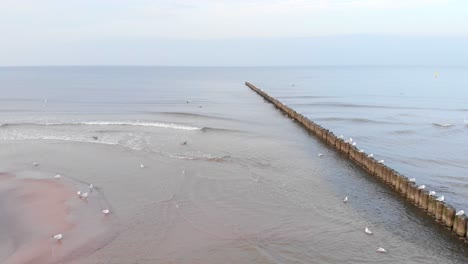 Aerial-shot-of-sandy-beach-in-Ustka-in-winter