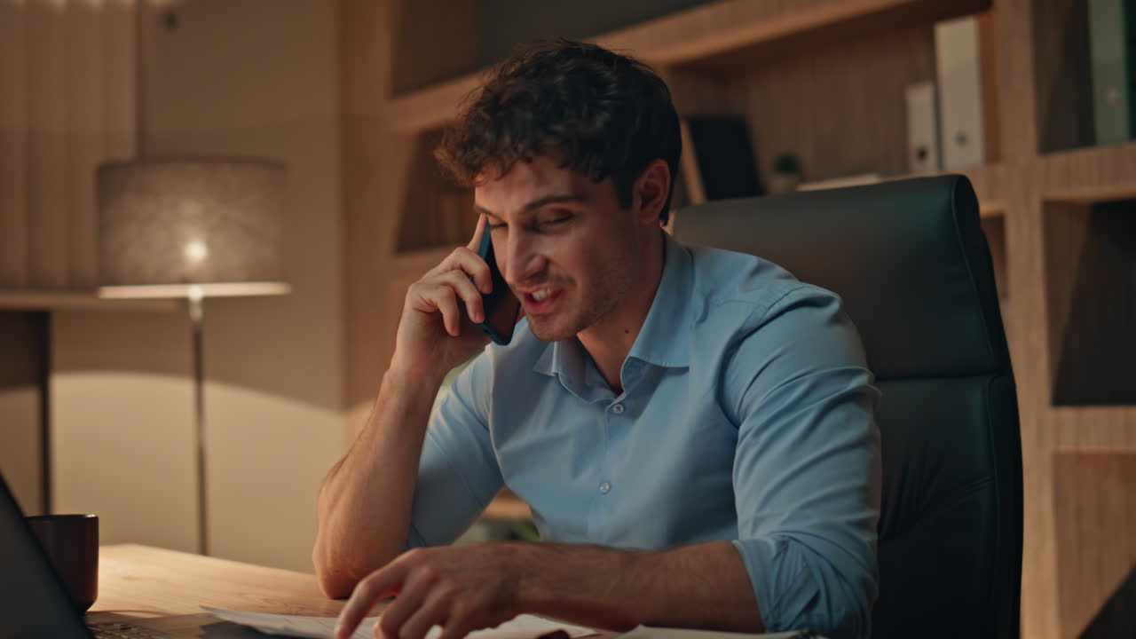 Busy worker calling cellphone working at dark workplace agency close up.