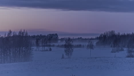 remote snow covered countryside in winter, day to night time lapse