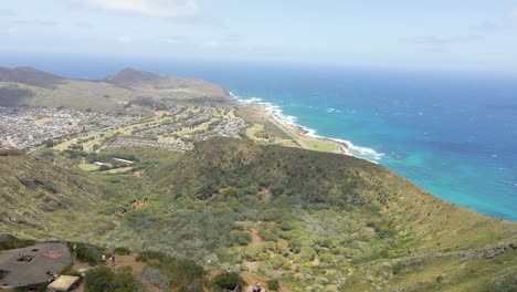 Tropical-island-mountain-range-view-with-ocean-water-coastline-in-background-and-you-can-see-the-ocean-horizon-line