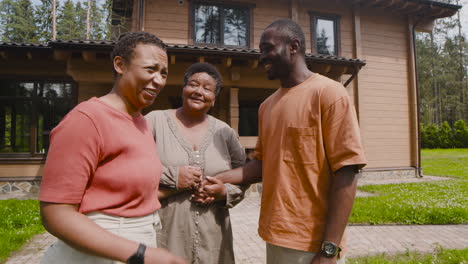 couple saying goodbye to loving man's mother in the yard and then leaving