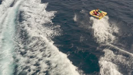 people enjoying a tube ride on a boat