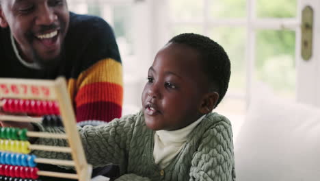 black family, abacus and father with child