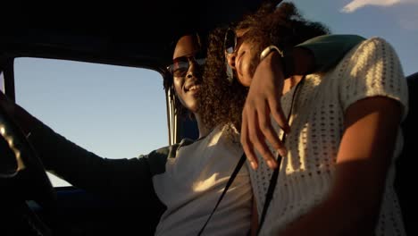 couple sitting together in pickup truck a beach 4k