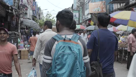 Busy Street Scene in India with People and Umbrellas