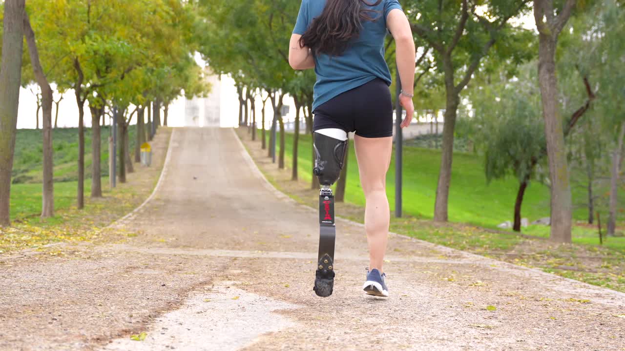Woman with Prosthetic Leg Running in Park