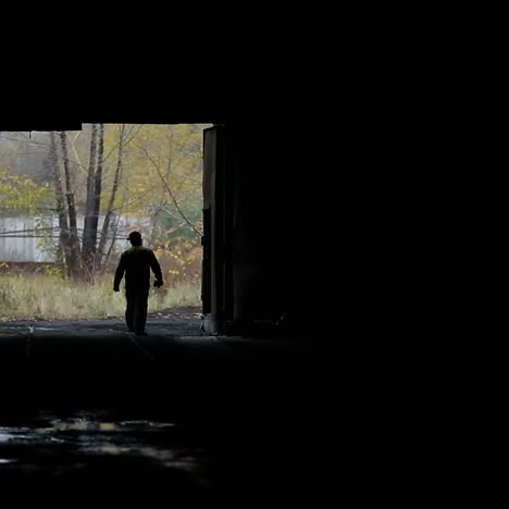 silhouette of workman in shop
