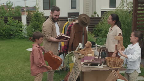 man and boy looking at items at garage sale