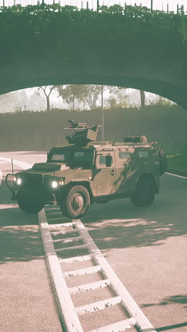 military armored vehicle driving under a bridge