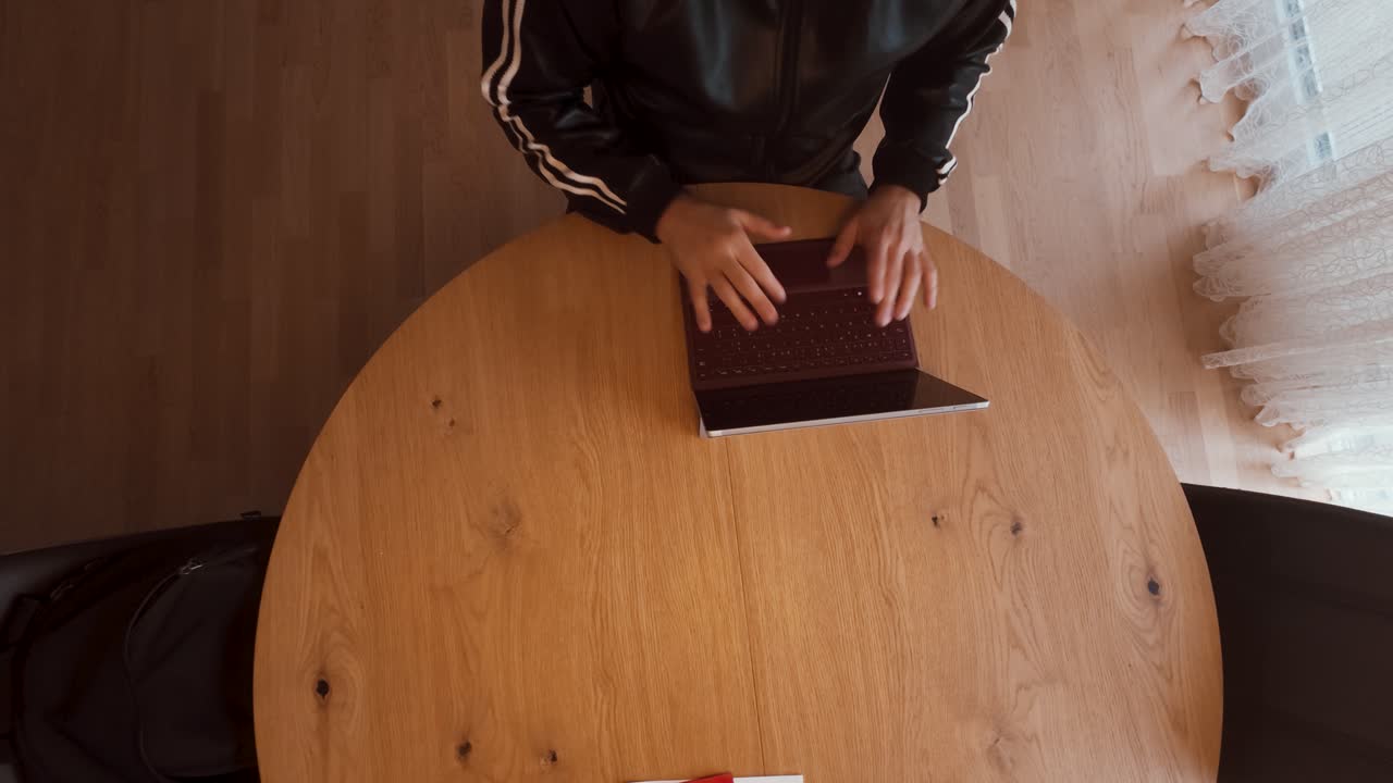 A real estate agent sits at a wooden table with a laptop, red folder, and key, reviewing documents. Perfect for housing, property sales, rentals, insurance, or mortgage business themes