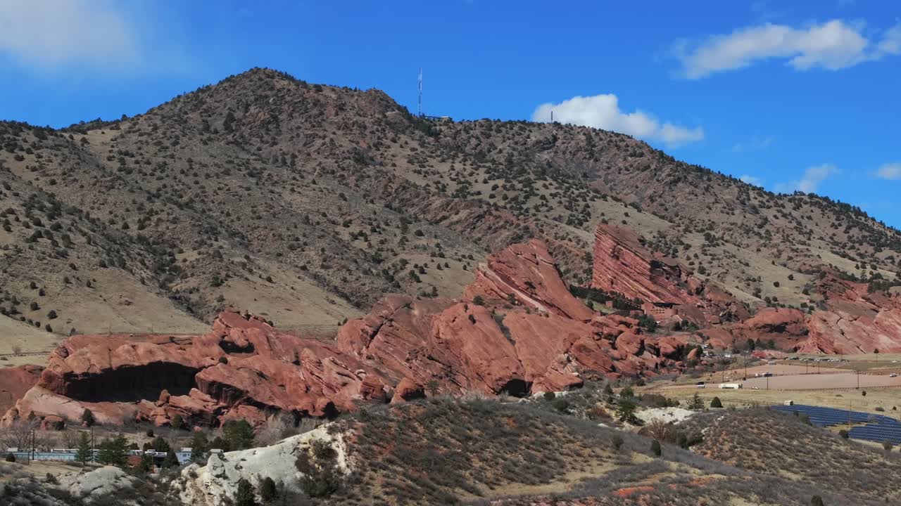 Mount Morrison Colorado aerial drone Red Rocks Park and Amphitheater mid winter no snow Bear Creek trails Trading Post sunny blue sky clouds solar panel parking lot pan right motion