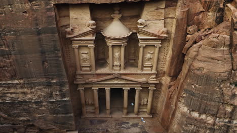 aerial view tilting away from the treasury facade, al-khazneh in petra, jordan