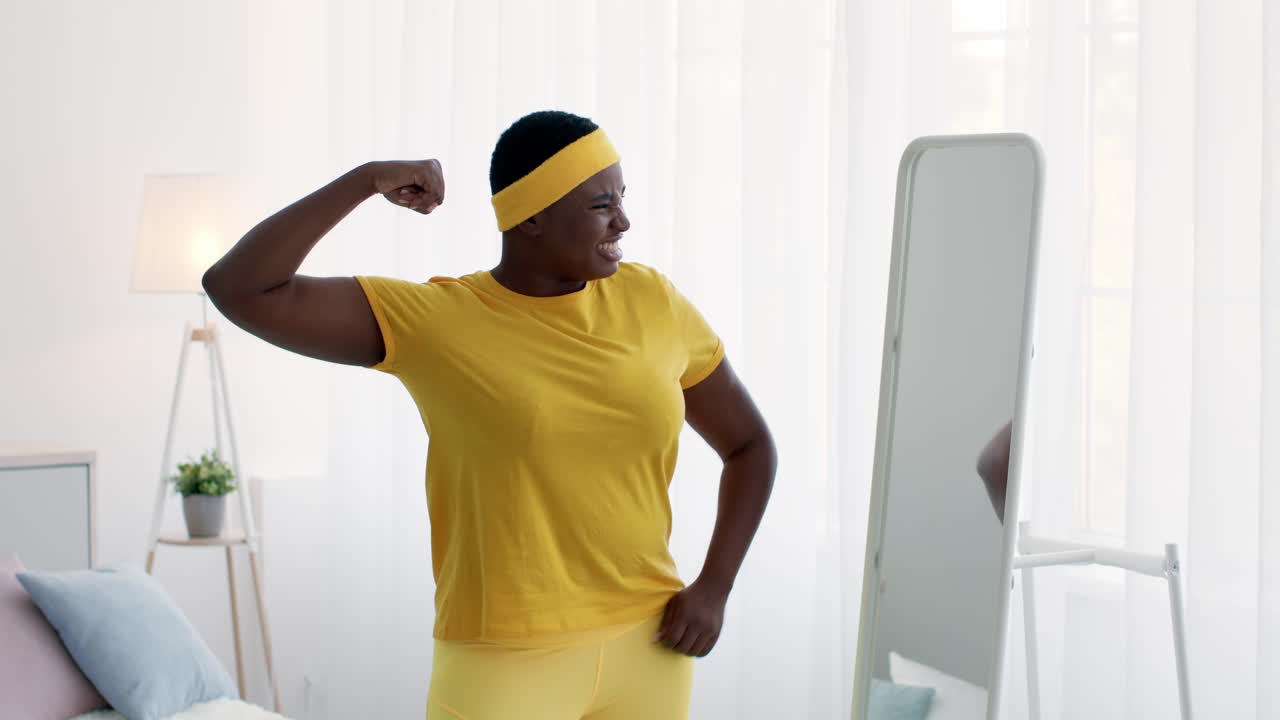 Plus-size woman working out in front of a mirror
