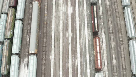 Slow-aerial-pullout-above-railroad-yard-with-containers-parked-on-tracks