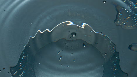 blob splashing inside glassware closeup. drop falling cocktail in slow motion