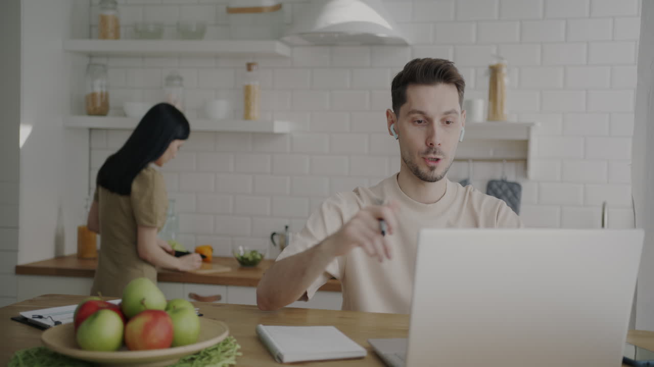 Couple working from home in the kitchen