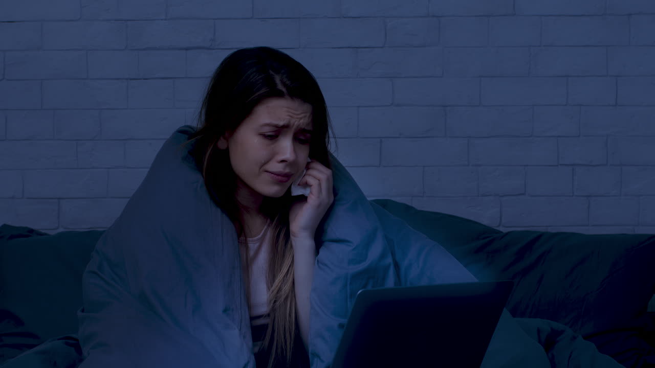 Woman Crying in Bed at Night