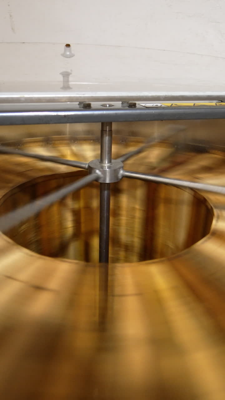 Extracting fresh organic honey in the electric centrifuge appliance. Special machine with centrifuge mechanism rotates the frames with honey. Vertical video