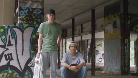 caucasian skateboarders in a ruined building.