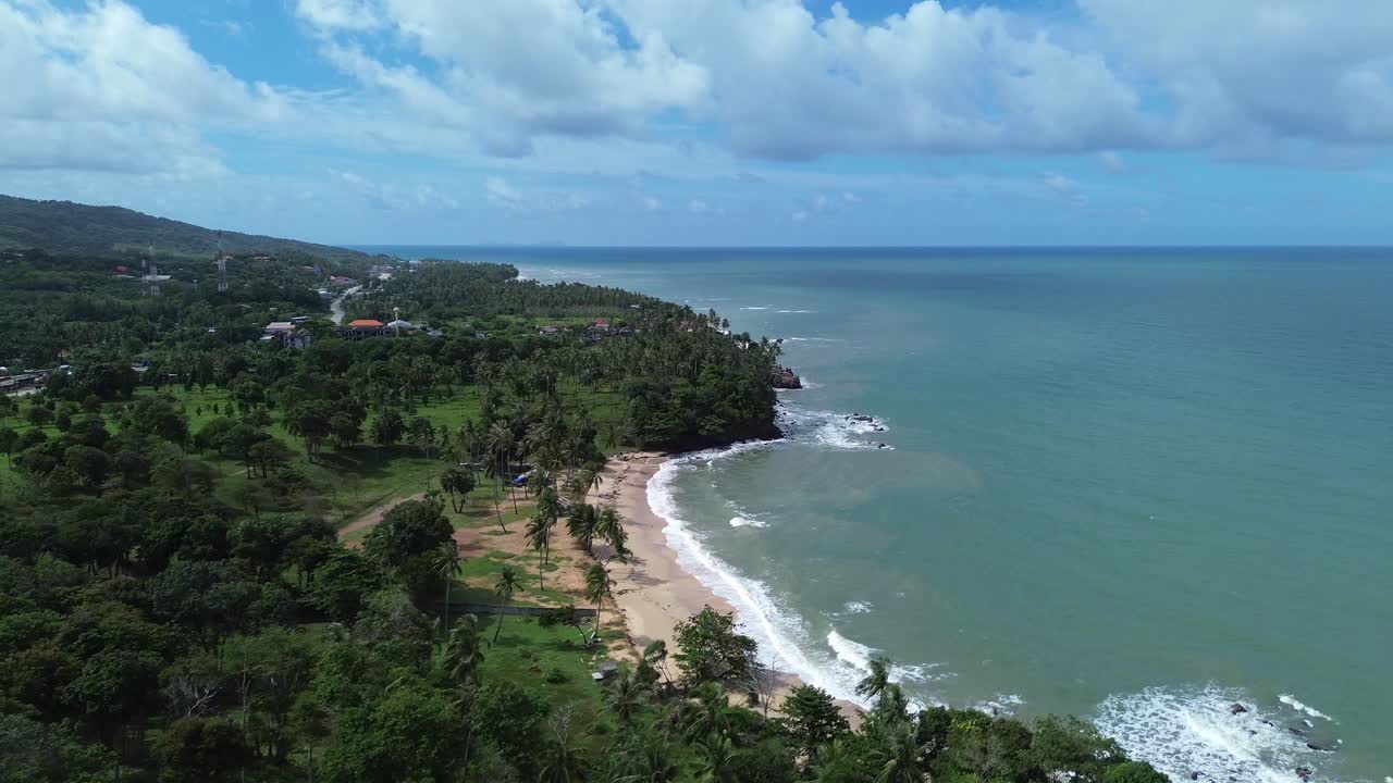 Low altitude drone footage gliding over Koh Lanta beach with turquoise water, golden sand and vast open sea horizon, highlighting tropical island beauty in southern Thailand