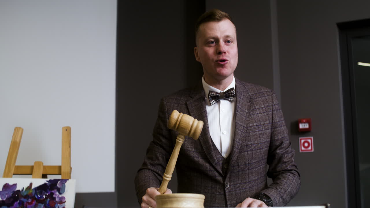 Man in elegant suit with gavel