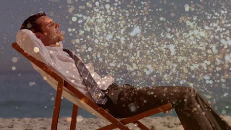 animation of light spots over caucasian businessman lying at beach