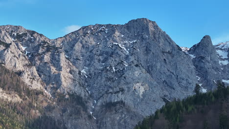 aerial view of steep rocky hills and evergreen forest in alps, upper austria