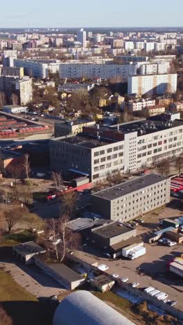 vertical aerial drone view of industrial area with warehouses and large apartment buildings. eastern european city from above.
