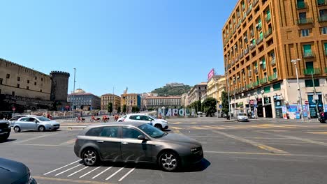 cars navigating a bustling naples intersection