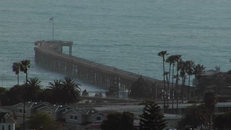 a pier curves out into the ocean