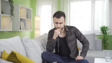 Depressed-young-man-is-thinking-and-upset-at-home.