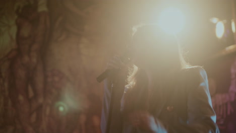 woman singing on stage