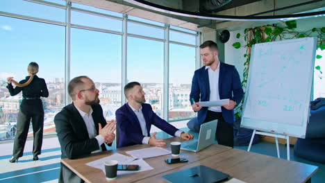 teamwork of businessmen. group of successful entrepreneurs talking in office room on the background of city with window view.