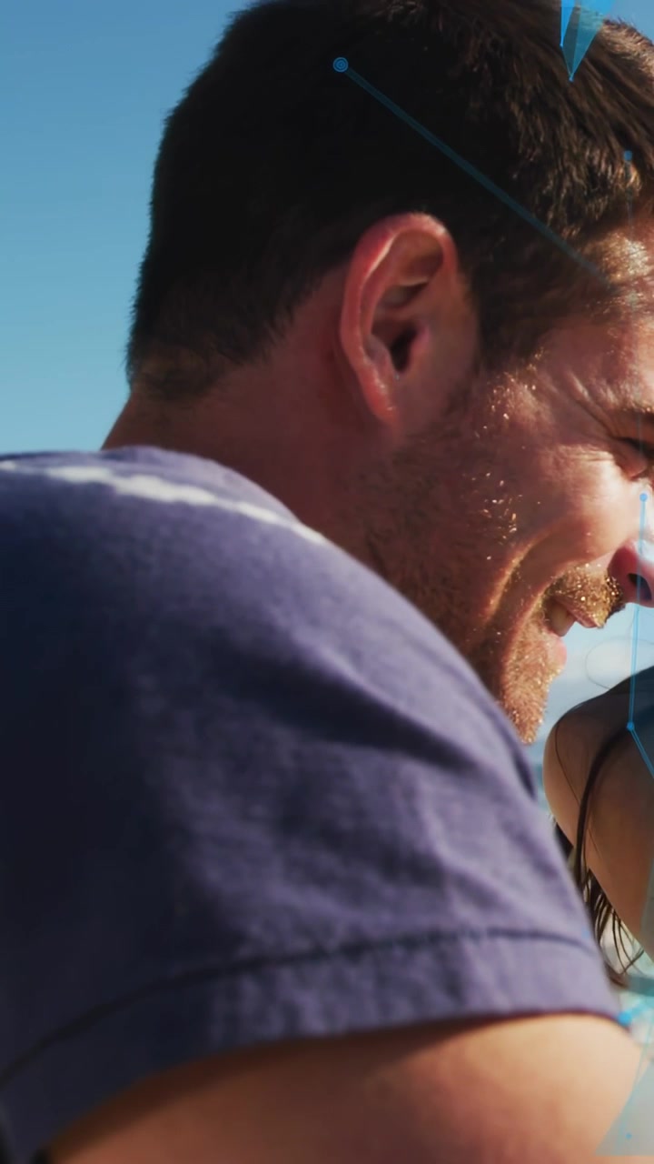 Vertical video: Forearm entering, revealing man leaning toward woman, engaging under blue triangles