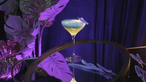 elegant cocktail with decorative feather garnish