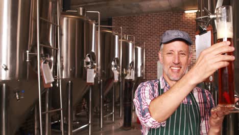 brewery worker checking the product