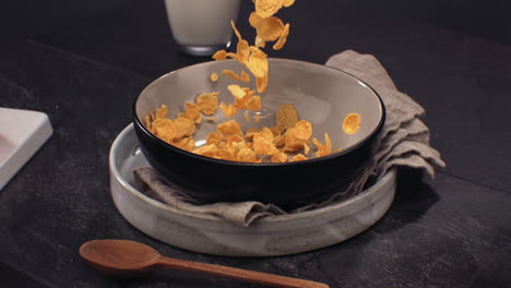 super slow motion golden yellow crispy cornflakes falling into bowl, healthy breakfast. shot with high speed camera at 420 fps