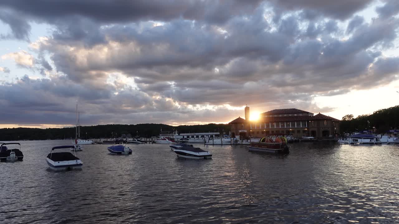 Boats near a pier on a cloudy evening during sunset