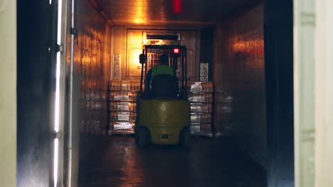 forklift truck shipping packaged of milk bottles. dairy industry. milk delivery