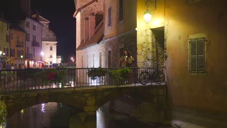 couple caught by people in a canal in annecy at night. romantic moments