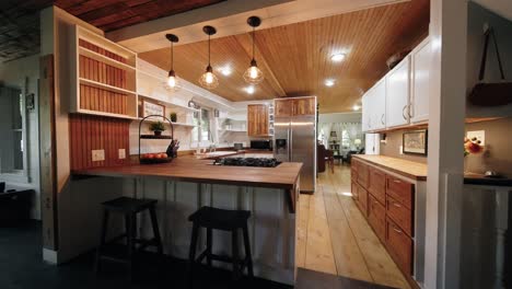 a push-in shot of a farmhouse kitchen adorned with modern white finishes and charming wood accents